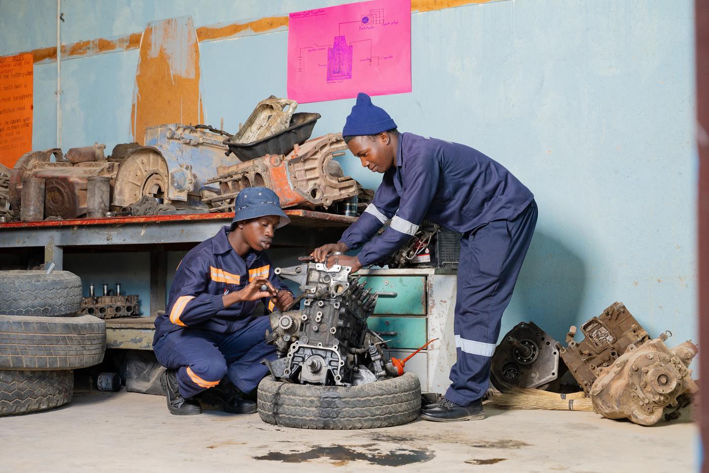 Students working on motor mechanics engine practical